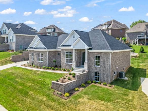 Elegant brick house with modern design and spacious yard.