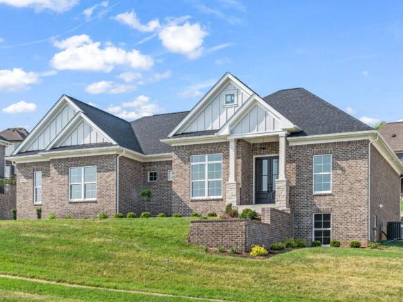Beautiful brick house with white accents and a well-maintained lawn.