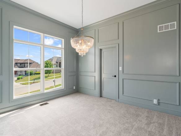 Bright interior with large window and elegant chandelier at 5609 Morningside Drive.