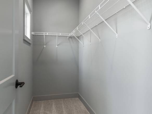 Closet storage with white wire shelving in a new home.
