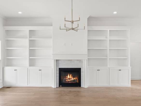 Built-in white bookshelves and fireplace in a contemporary living room.
