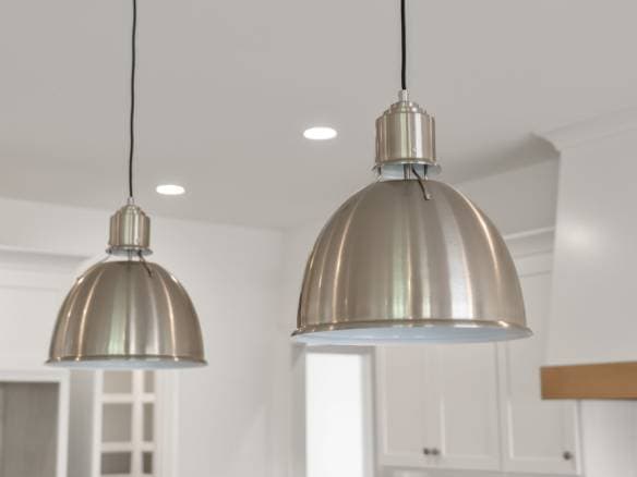 Pendant lights over kitchen island for modern design.