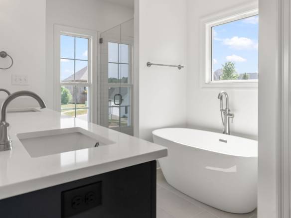 Beautiful contemporary bathroom with a freestanding tub and large windows.