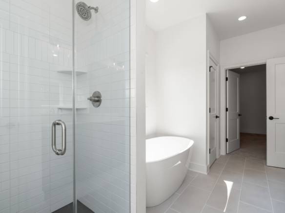 Modern bathroom with a glass-enclosed shower and freestanding bathtub. Bright, clean, and stylish de.