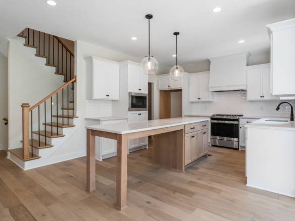 Bright, modern kitchen with white cabinets and wooden accents at 5611 Morningside Drive.