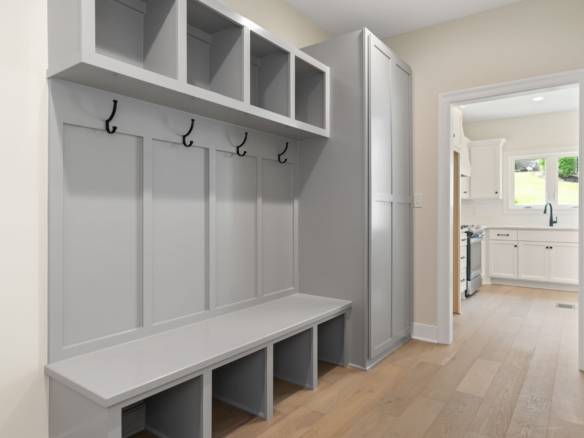 Mudroom storage with hooks and bench at 5611 Morningside Drive.