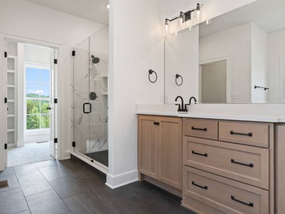 Modern bathroom featuring a walk-in shower with glass enclosure and contemporary fixtures.