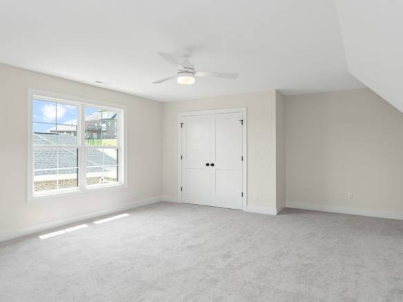 Bright, spacious bedroom with large window and neutral decor at 5611 Morningside Drive.