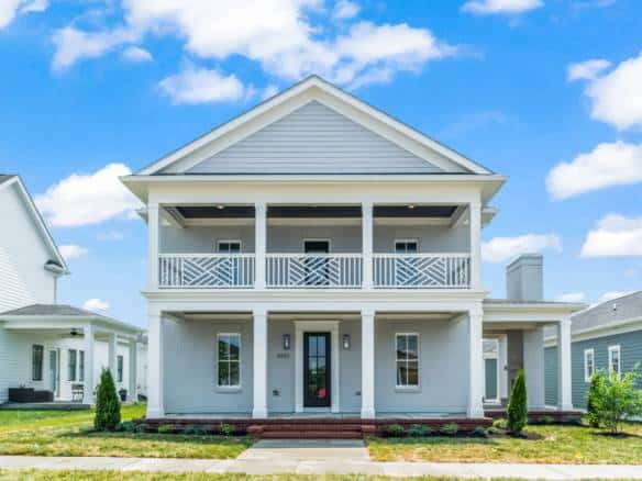 Beautiful two-story home with spacious front porch and modern design.