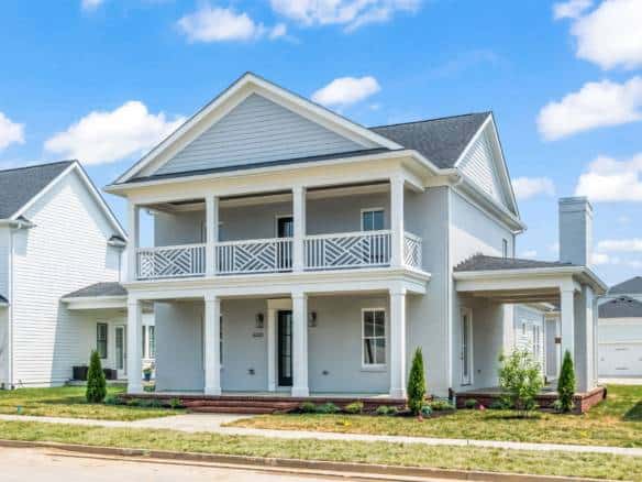 Beautiful new construction home with a spacious front porch and elegant design.