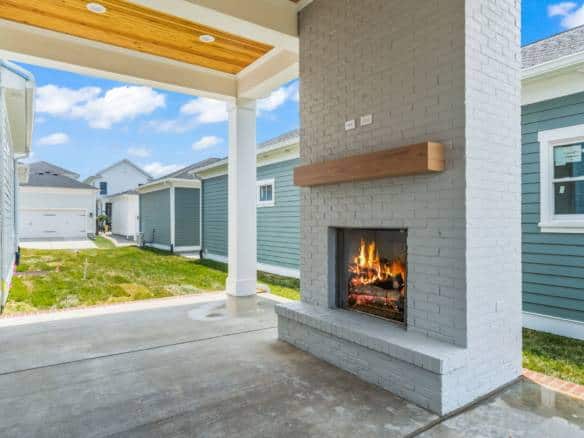 Outdoor fireplace with a cozy fire on a sunny day.