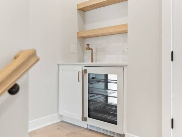 Modern kitchen bar with built-in wine cooler and minimalist design.