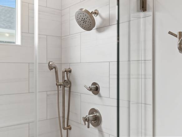 Bathroom shower with sleek fixtures and glass enclosure.