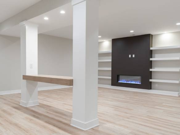 Spacious living area featuring a sleek fireplace, built-in shelves, and contemporary design elements.