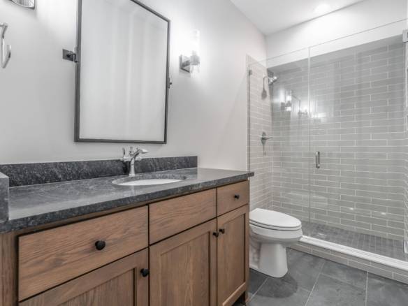 Bathroom vanity with granite countertop and mirror.