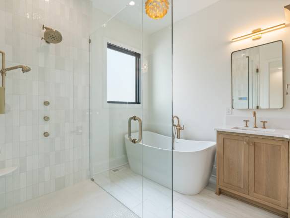 Modern bathroom featuring a freestanding bathtub and a spacious walk-in shower with glass enclosure.