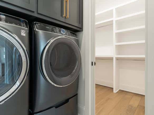 Washer and dryer units in a contemporary laundry space at 17423 Shakes Creek Drive.