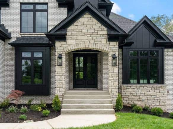 Beautiful exterior of a custom-built home with stone and black accents.