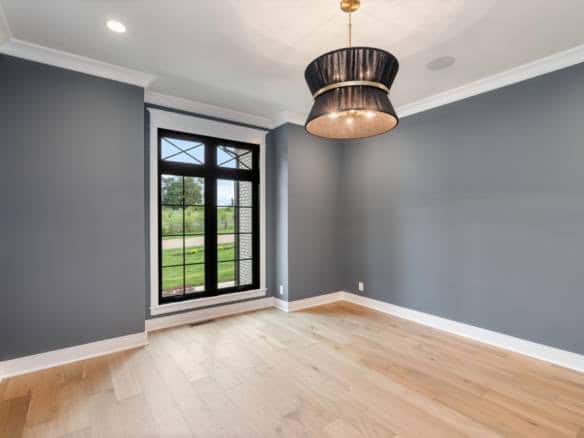 Interior room with large window and contemporary ceiling light fixture.
