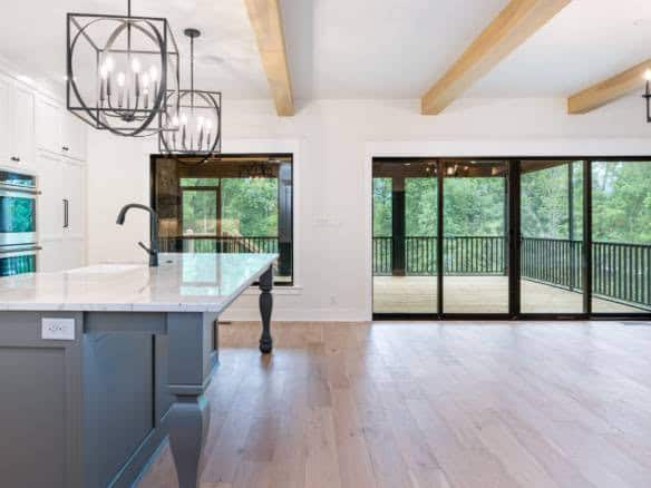 Modern kitchen with large sliding glass doors and open living space.