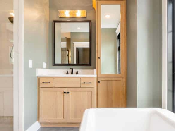 Bathroom vanity with mirror and natural wood finish for a contemporary look.