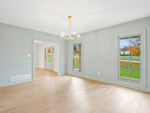 Bright living room with spacious windows and neutral wall paint.