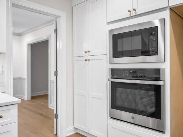 Modern kitchen with built-in microwave and oven appliances.