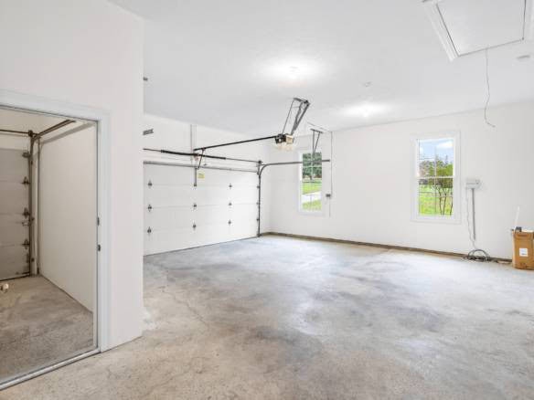 Garage with open door and spacious interior.