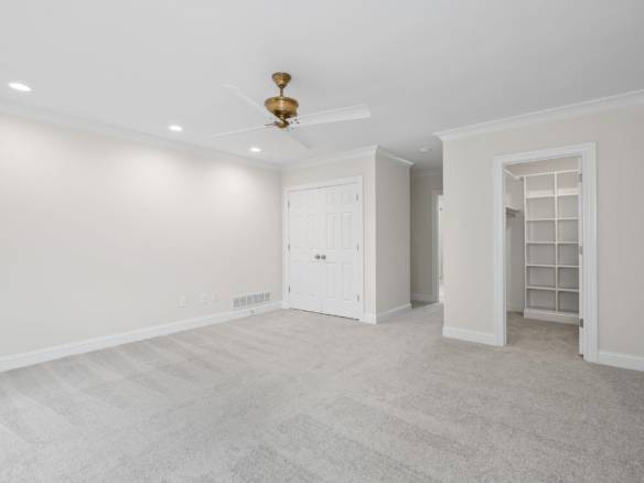 Bright, spacious living room with neutral walls and plush carpet.