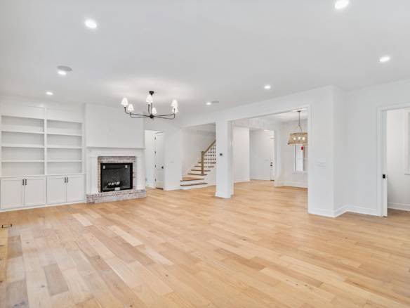 Spacious interior featuring hardwood flooring, a fireplace, and bright natural light at 3979 Hidden.