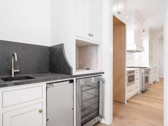 Modern kitchen with white cabinets and stainless steel appliances for a sleek look.