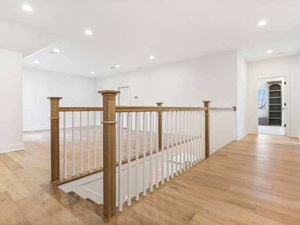 Interior view of a spacious, well-lit home at 3979 Hidden Falls Drive with wooden flooring and white.
