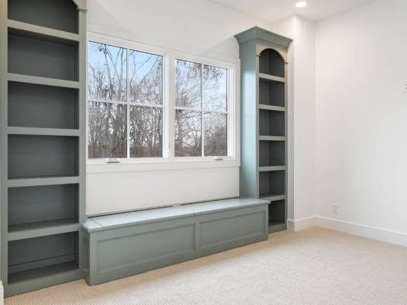 Custom built-in shelves and window seat in a modern home interior.