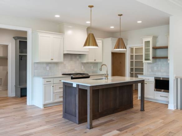 Modern kitchen with white cabinets and a central island.