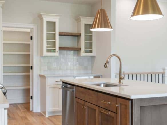 Kitchen with white cabinetry, wooden accents, and modern appliances.
