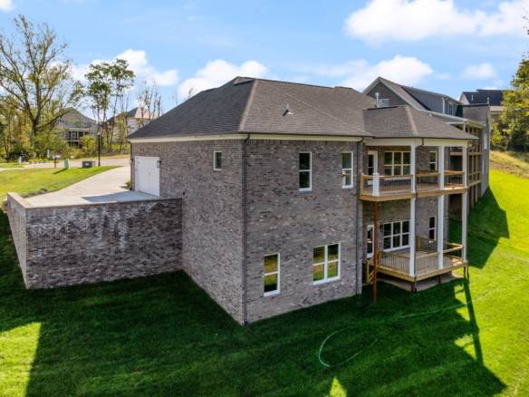 New construction of a modern brick house with multiple decks at 6307 Leyton Court.
