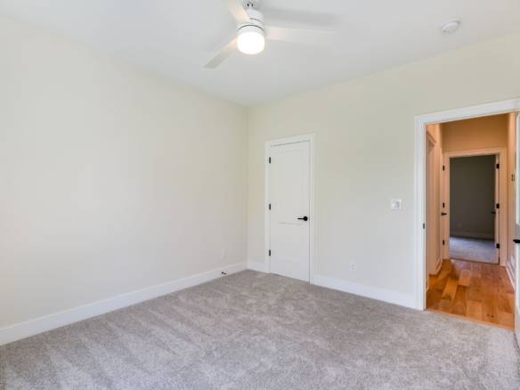 Interior room with neutral walls and carpet flooring at 6307 Leyton Court, built by Mason Constructi.