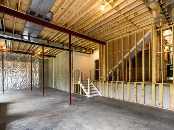 New home under construction with exposed framing and open interior space.