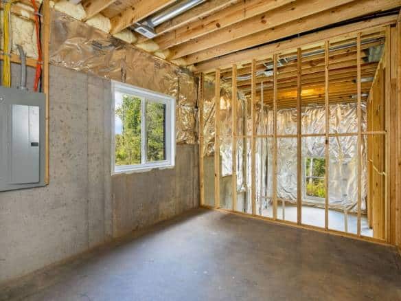 Interior view of a new home under construction with framing and insulation.