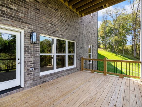 Modern brick house with spacious wooden deck at 6307 Leyton Court.
