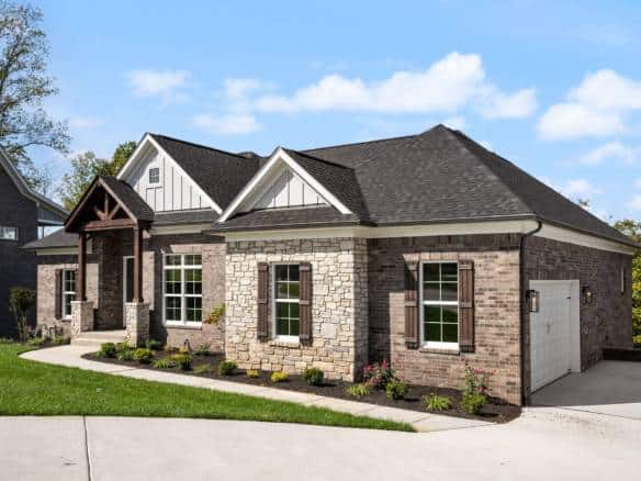 Beautiful new construction of a Craftsman-style house with stone and siding exterior.