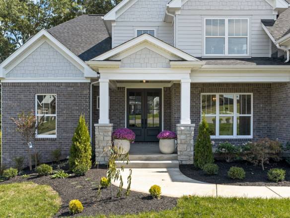 Beautiful new construction home with a welcoming porch and landscaped yard.