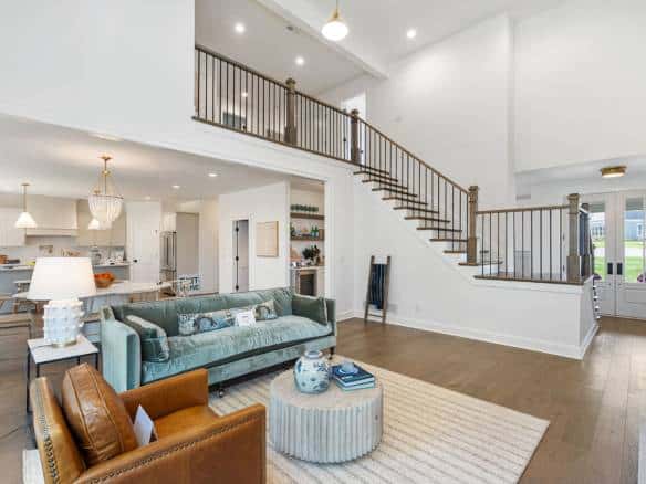 Spacious living room featuring high ceilings, large windows, and contemporary furniture in a newly r.