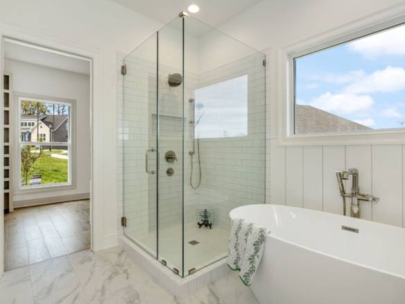 Modern bathroom with glass shower and freestanding tub at 6308 Leyton Court.