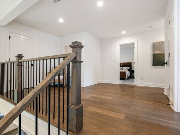 Interior of a newly renovated home with hardwood floors and bright lighting.