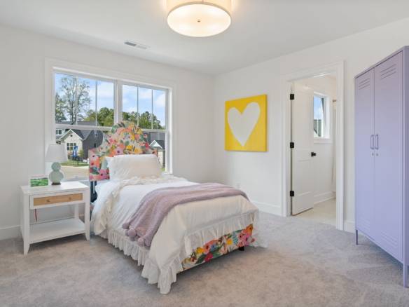 Bright, renovated bedroom with colorful accents and natural light.
