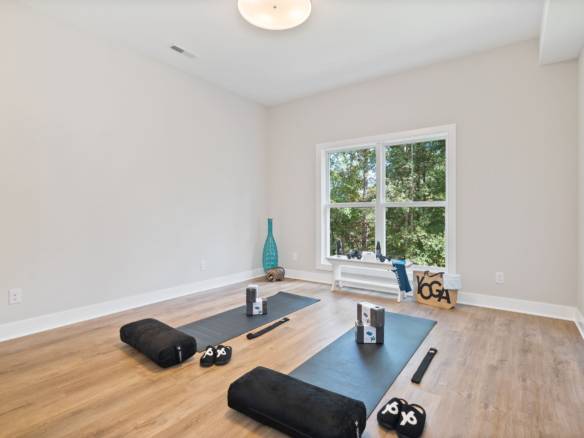 Yoga room with natural light and hardwood floors at 6308 Leyton Court.