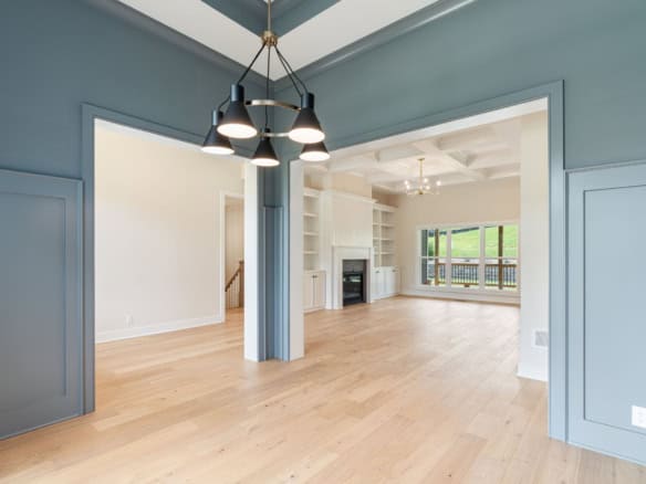 Spacious living room featuring a fireplace, built-in shelves, and abundant natural light.