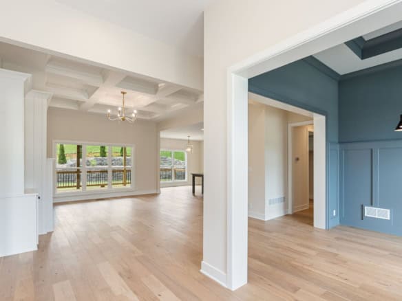 Spacious living area with large windows and elegant ceiling design at 6209 Brentwood Dr.