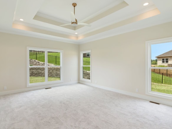 Spacious living room with large windows and elegant ceiling design.
